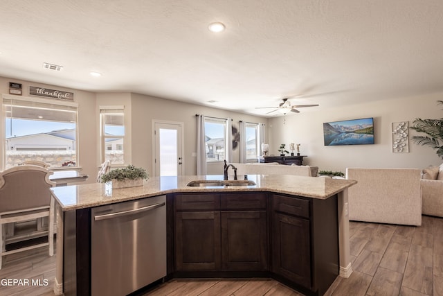 kitchen with light wood-style flooring, a sink, visible vents, open floor plan, and dishwasher