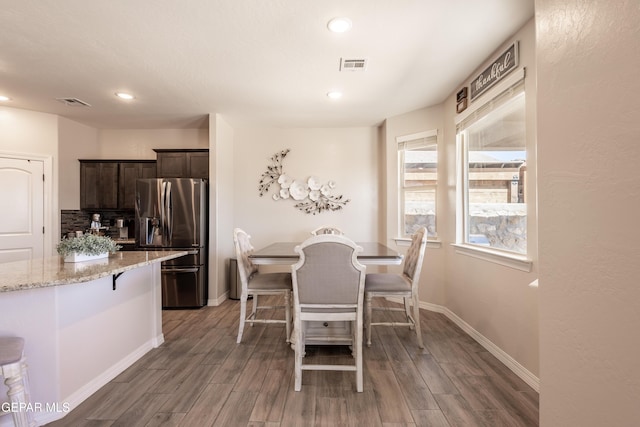 dining room featuring visible vents, baseboards, wood finished floors, and recessed lighting