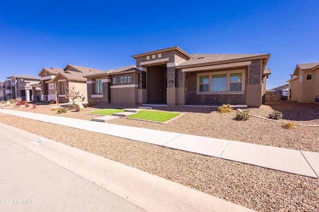 prairie-style house with a residential view, stone siding, and stucco siding