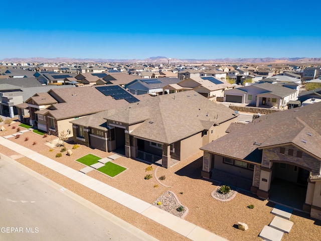 drone / aerial view featuring a residential view and a mountain view