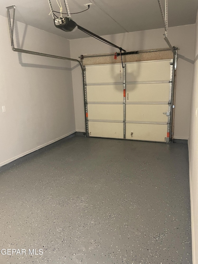 garage featuring baseboards and a garage door opener