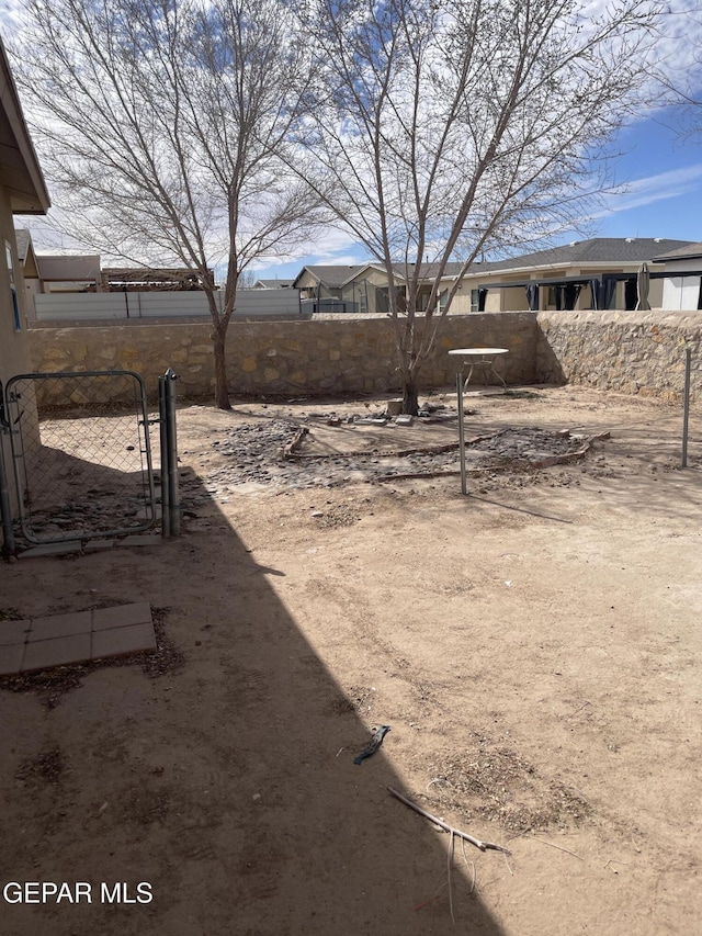 view of yard featuring a gate and fence