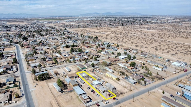 birds eye view of property with a mountain view and a desert view