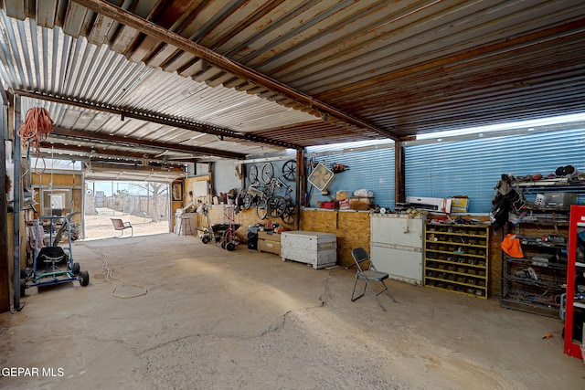 garage featuring metal wall and a workshop area