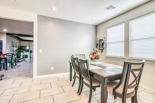 dining room with a textured ceiling, recessed lighting, visible vents, and baseboards