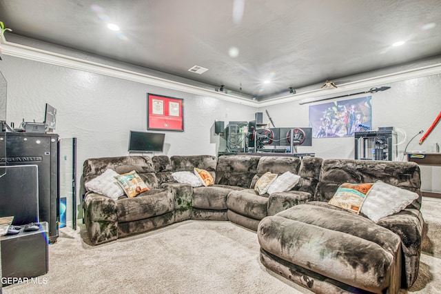 home theater room featuring a textured wall, recessed lighting, carpet flooring, visible vents, and ornamental molding