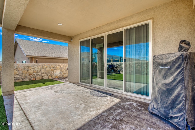 view of patio featuring fence