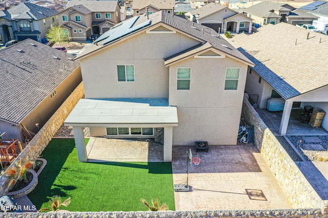 exterior space with a residential view, a lawn, a patio, and stucco siding