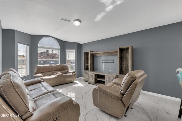 living room featuring lofted ceiling, marble finish floor, baseboards, and visible vents