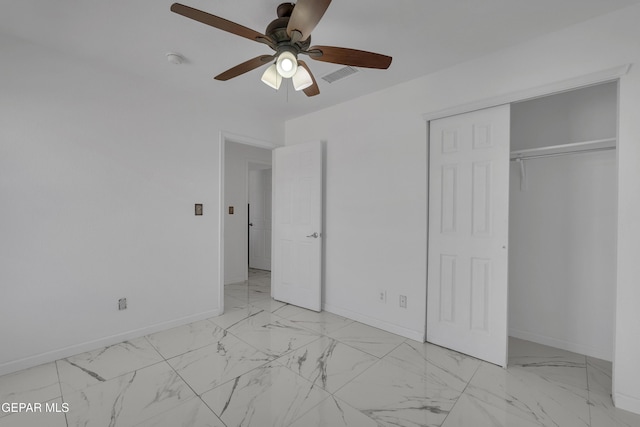 unfurnished bedroom featuring a closet, marble finish floor, visible vents, and baseboards