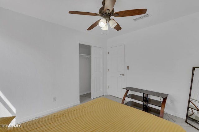 unfurnished bedroom with marble finish floor, a closet, visible vents, a ceiling fan, and baseboards