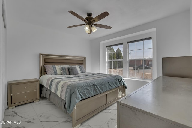 bedroom featuring marble finish floor and a ceiling fan