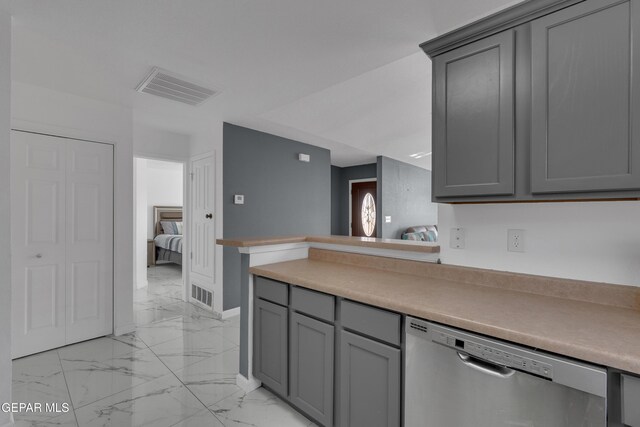 kitchen featuring gray cabinets, marble finish floor, visible vents, and stainless steel dishwasher