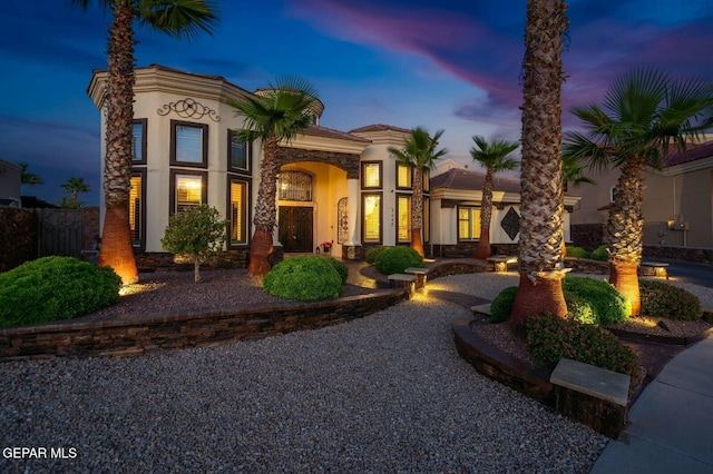 mediterranean / spanish house featuring stucco siding