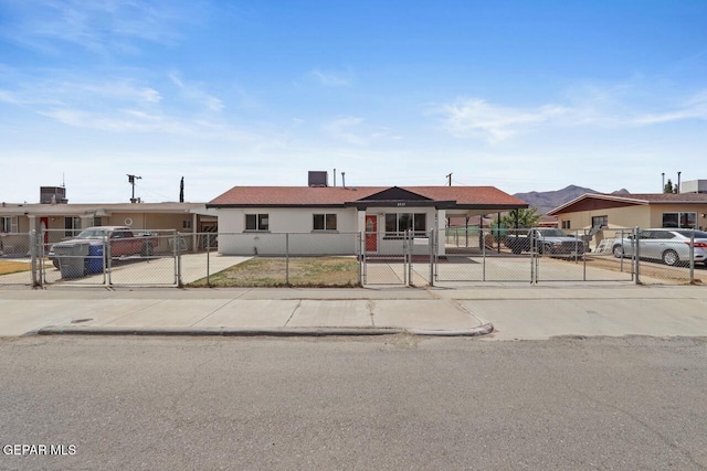 view of front facade featuring a fenced front yard and a gate