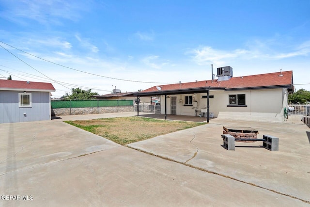 rear view of property with a patio area, fence, and central AC unit