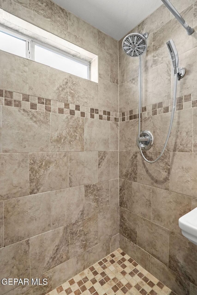 full bath featuring tiled shower