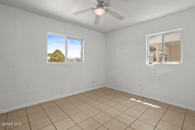 unfurnished room featuring baseboards and a ceiling fan