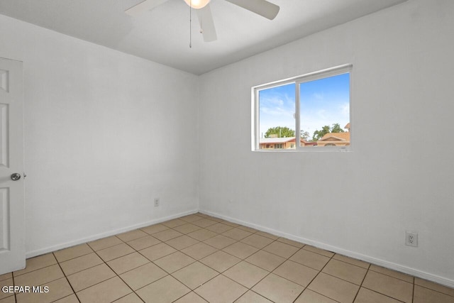 empty room with baseboards and a ceiling fan