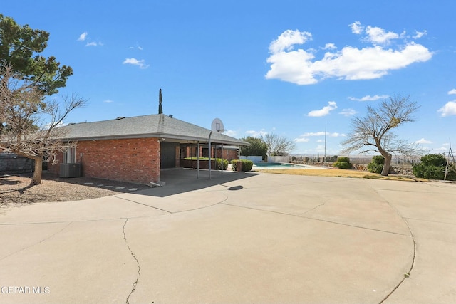 view of side of property with a patio and brick siding