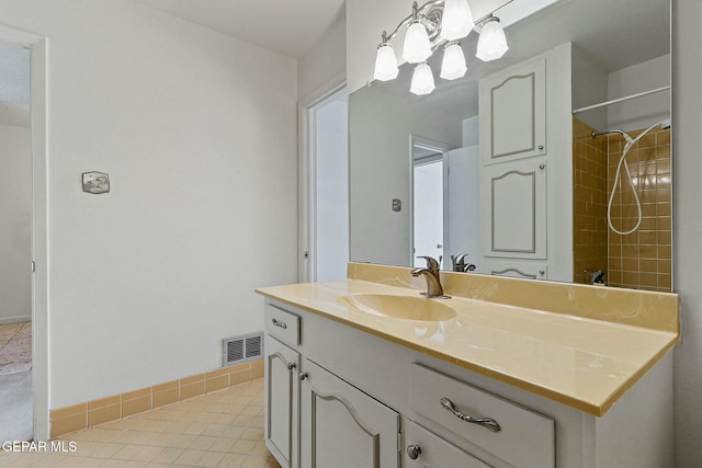 bathroom with tile patterned flooring, visible vents, baseboards, and vanity