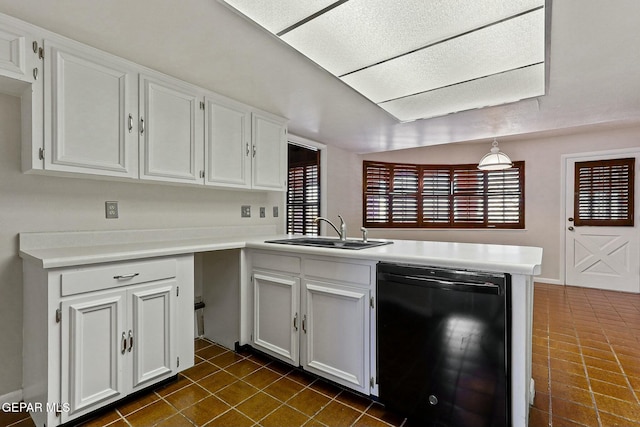 kitchen with black dishwasher, light countertops, white cabinets, a sink, and a peninsula