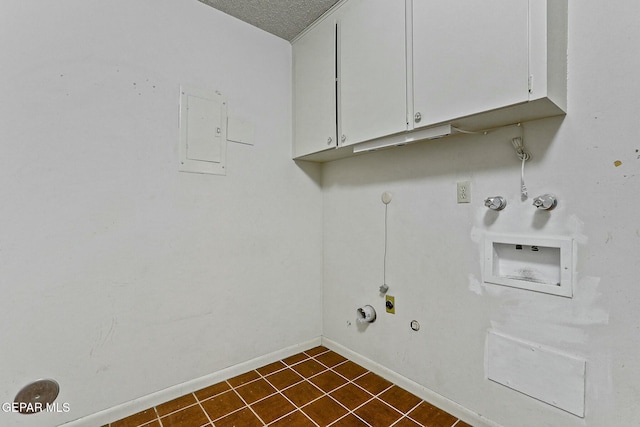 laundry area featuring washer hookup, hookup for a gas dryer, cabinet space, electric panel, and baseboards