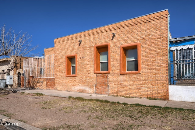 view of property exterior featuring brick siding