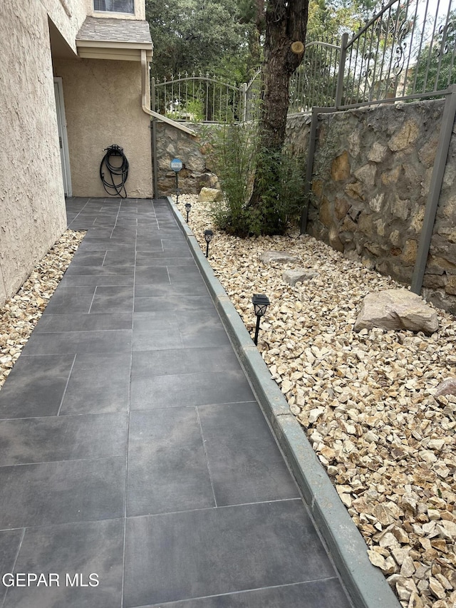 view of patio featuring fence