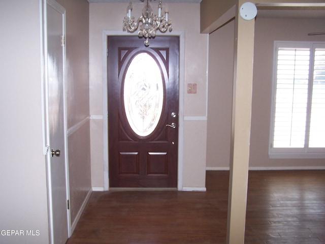 entrance foyer featuring a chandelier, baseboards, and wood finished floors