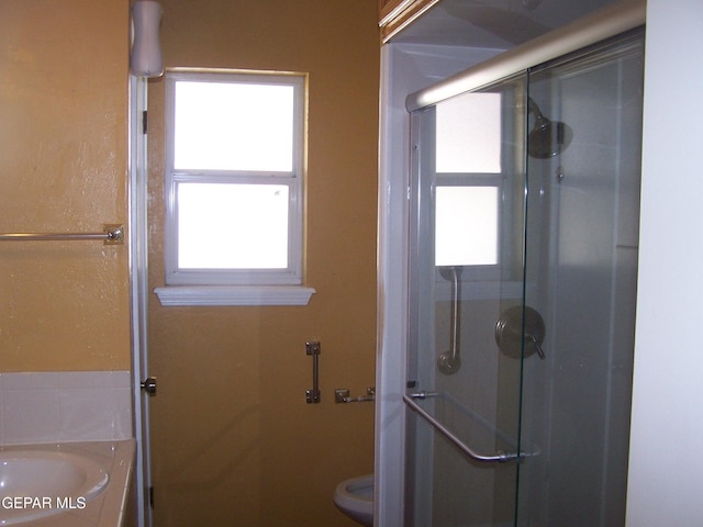 bathroom featuring toilet and a stall shower