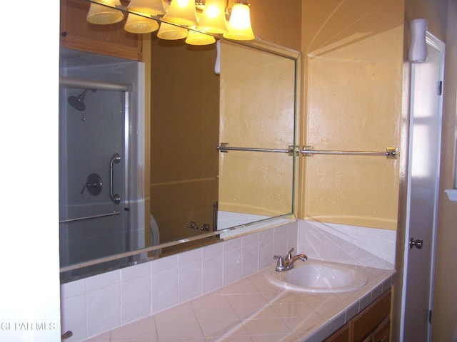 bathroom featuring a sink and a shower with shower door