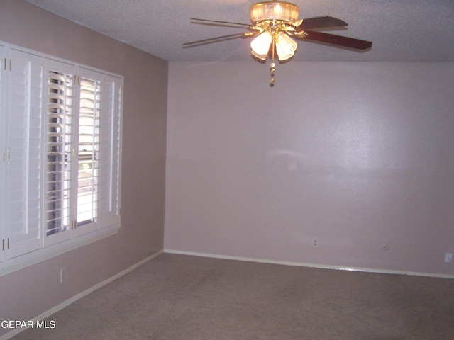 unfurnished room with a ceiling fan, baseboards, a textured ceiling, and carpet flooring