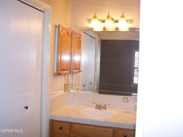 bathroom featuring tasteful backsplash and vanity