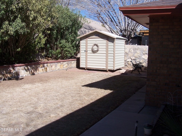 view of yard with an outbuilding, a patio area, and a storage unit