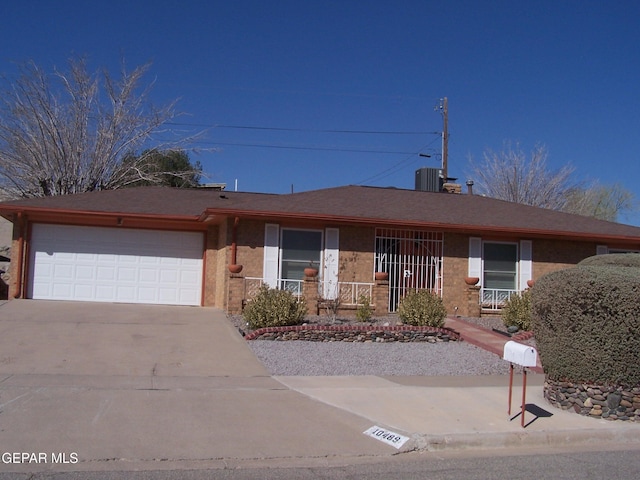 single story home featuring a garage and concrete driveway