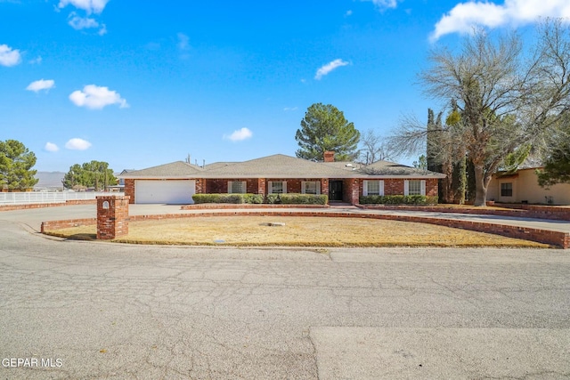 ranch-style house with brick siding, driveway, and an attached garage