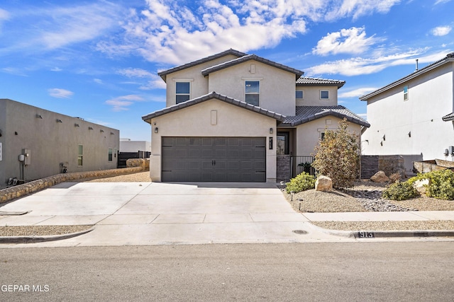 view of front of house featuring an attached garage, a tiled roof, concrete driveway, and stucco siding