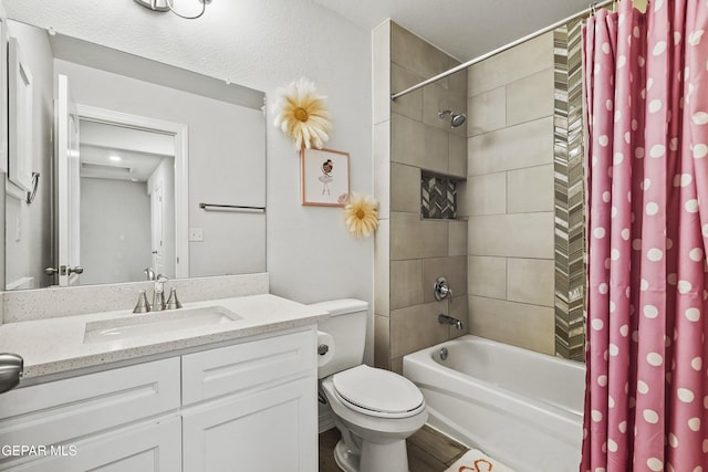 bathroom with shower / tub combo, vanity, and toilet