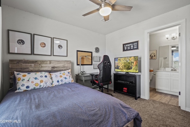 bedroom featuring ceiling fan, connected bathroom, baseboards, and carpet flooring