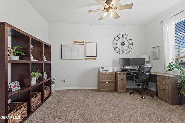 office space featuring a ceiling fan, light carpet, and baseboards