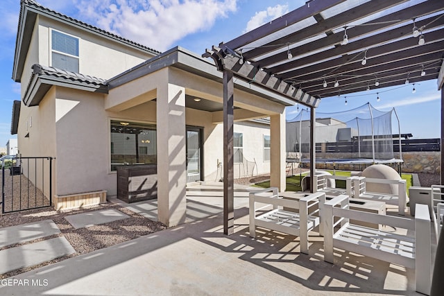 view of patio / terrace featuring a trampoline, fence, and a pergola