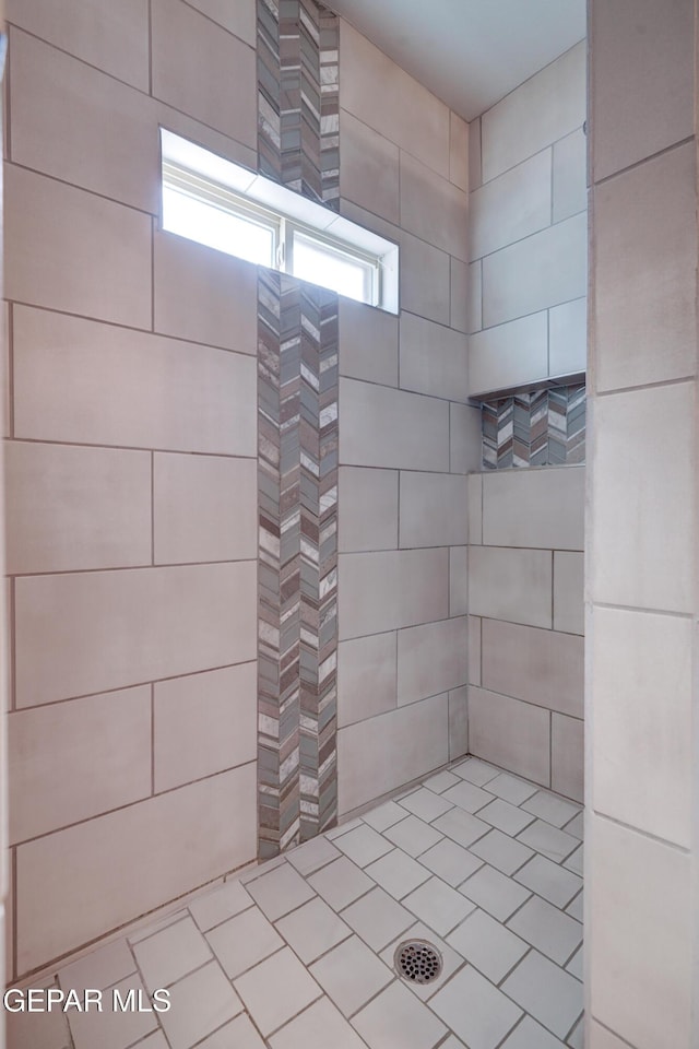 bathroom with tiled shower