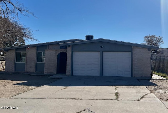 ranch-style house featuring fence, cooling unit, brick siding, an attached garage, and driveway