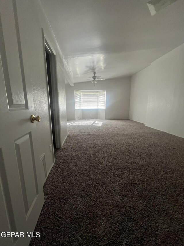 carpeted empty room with a ceiling fan