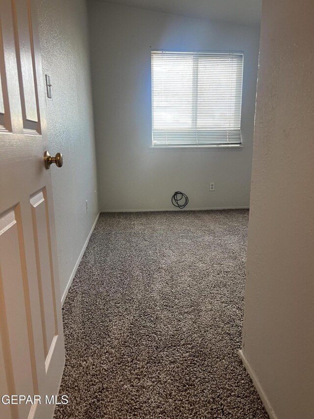 empty room featuring baseboards