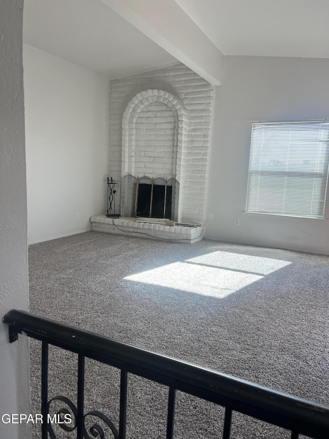 unfurnished living room featuring carpet flooring and a fireplace