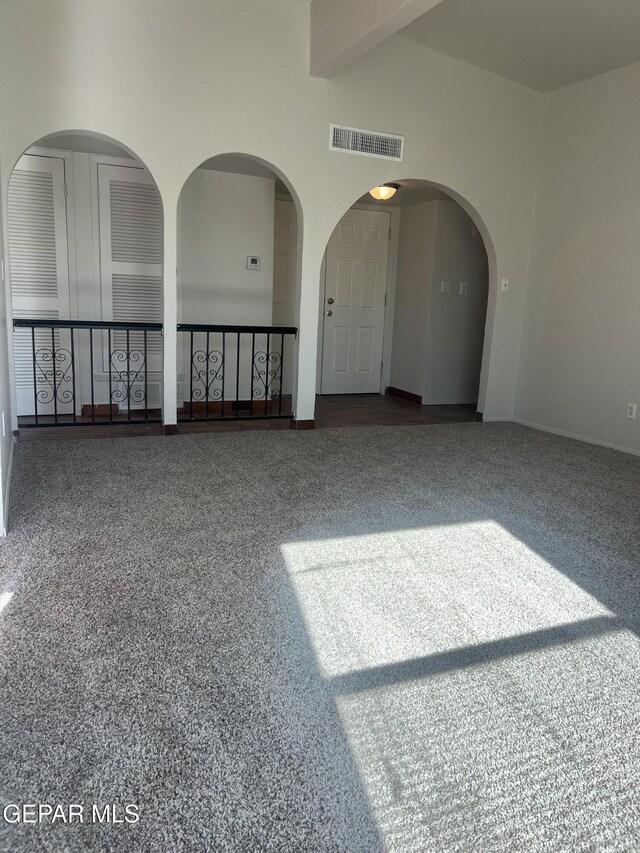 empty room featuring baseboards and visible vents