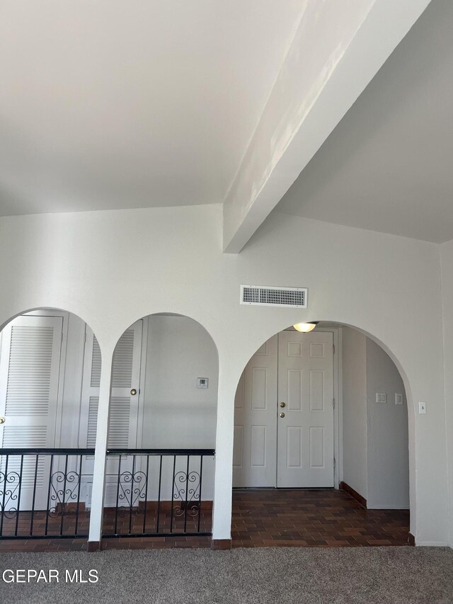 interior space with visible vents, arched walkways, and baseboards
