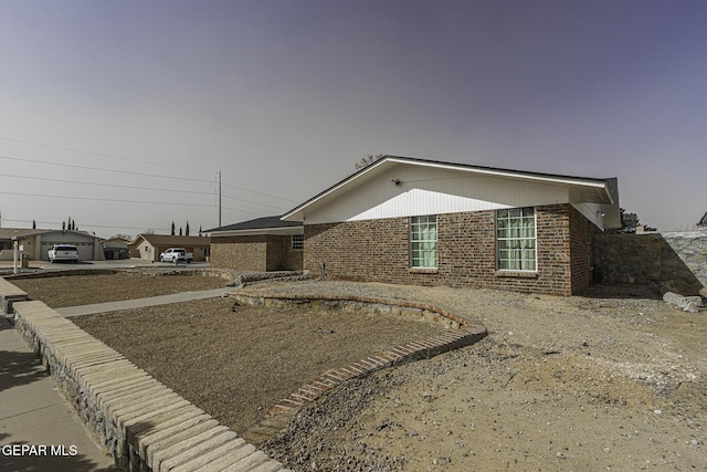 ranch-style home featuring brick siding